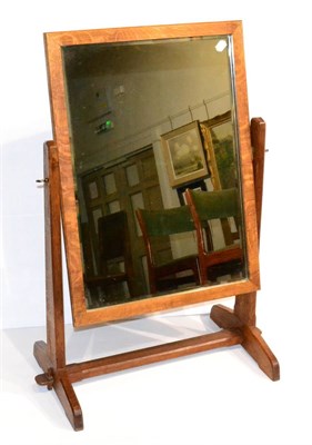 Lot 640 - An Arts & Crafts Oak Free Standing Mirror, the rectangular bevelled edged mirror on chamfered...