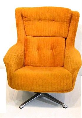 Lot 653 - A 1960's German Swivel Chair, orange upholstery, cushions labelled RUCKENKISSEN BACK CUSHION...