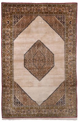 Lot 837 - Good Ghom Silk Rug Central Persia The plain pale camel ground with central stepped lozenge...