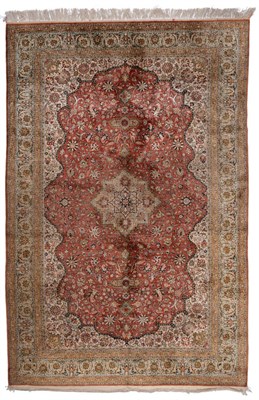 Lot 863 - Ghom Silk Carpet Central Persia The deep brick red field of scrolling vines and palmettes...