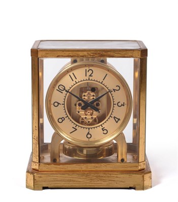 Lot 878 - An Atmos Clock, signed Jaeger LeCoultre, 20th century, glass panels, champagne coloured dial...