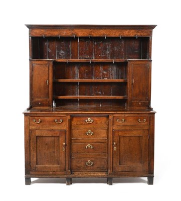 Lot 962 - A George III Oak Dresser, the rack with a moulded cornice hung with hooks, over three shelves...