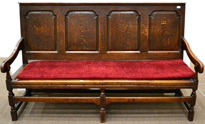 Lot 972 - A George III Joined Oak Settle, the back with four fielded arched panels between downcurved...