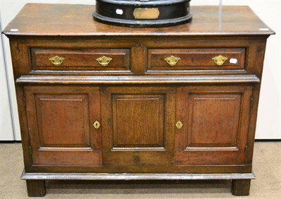 Lot 974 - A Joined Oak Low Cupboard, the moulded top over two frieze drawers with fielded fronts, over...