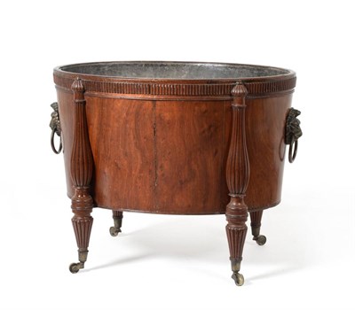 Lot 989 - A George III Mahogany Wine Cooler, of oval form, with a lead liner, lion's mask handles to each...