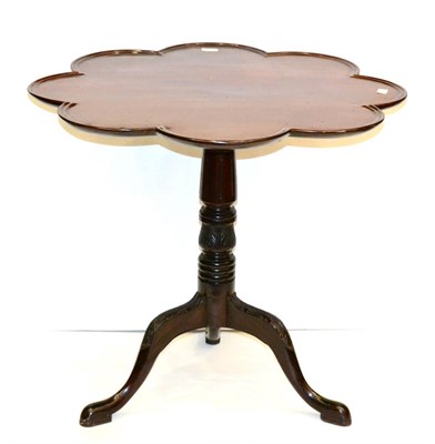 Lot 991 - A George III Mahogany Tripod Table, the associated lobed and moulded top above a baluster and...