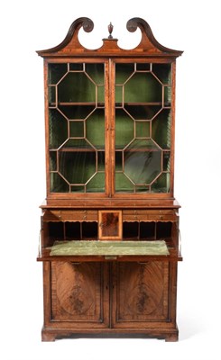 Lot 1005 - A George III Mahogany Secretaire Bookcase, with a scrolled pediment over two glazed doors enclosing