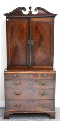 Lot 1010 - A George III Mahogany Chest and Bookcase, the upper part with a scrolled pediment centred by a...