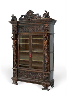 Lot 1051 - A Fine 19th Century Italian Carved Walnut Bookcase, in Baroque style, of breakfront form surmounted