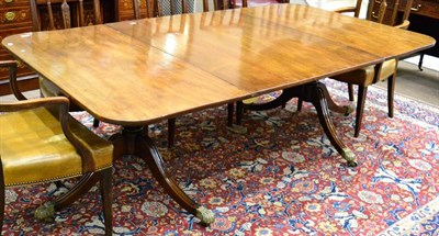 Lot 1056 - A George III Mahogany Dining Table, comprising two D-ends on baluster pillars and moulded sabre...