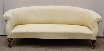 Lot 1078 - A Victorian Serpentine Shaped Sofa, circa 1870, recovered in cream fabric with overstuffed seat and