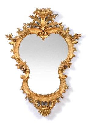 Lot 1114 - A 19th Century Italian Carved Giltwood Mirror, the cartouche-shaped plate within a scrolling...