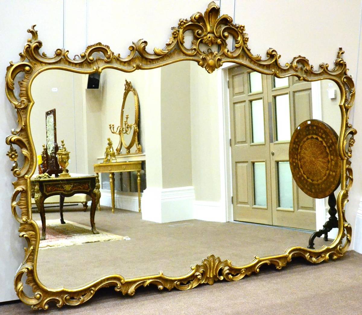 Lot 1119 - A 20th Century Gilt and Gesso Mirror, of large proportions, the rockwork frame with rococo...