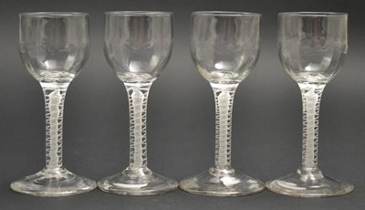 Lot 3 - A Set of Four Wine Glasses, circa 1760, the semi-fluted ovoid bowls on opaque twist stems, 13cm...
