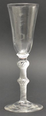 Lot 8 - An Ale Flute, circa 1750, the rounded funnel bowl with basal annular knop on a double knopped...