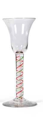 Lot 16 - A Colour Twist Wine Glass, circa 1760, the bell shaped bowl on a white, green and red spiral...