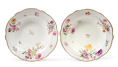 Lot 32 - A Pair of Nantgarw Porcelain Soup Plates, circa 1820, painted with scattered flower sprays and...