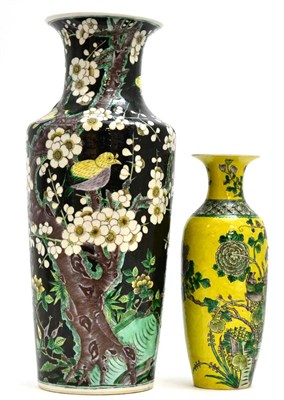 Lot 66 - A Chinese Famille Noire Rouleau Vase, 19th century, painted with birds in flowering prunus...