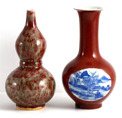 Lot 105 - A Chinese Sang de Boeuf Glazed Porcelain Double Gourd Vase, Qing Dynasty, 22cm high; and  A Similar
