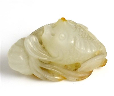 Lot 119 - A Chinese Jade Carving of a Fish, with some russet inclusions, 4cm long