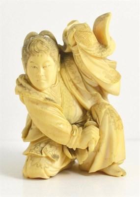 Lot 142 - A Japanese Ivory Okimono, Meiji period, of a kneeling warrior in flowing robes, 11.5cm high