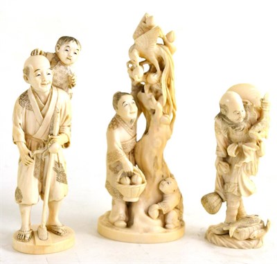 Lot 147 - A Japanese Ivory Okimono, Meiji period, as a man with a boy on his shoulder holding an apple...