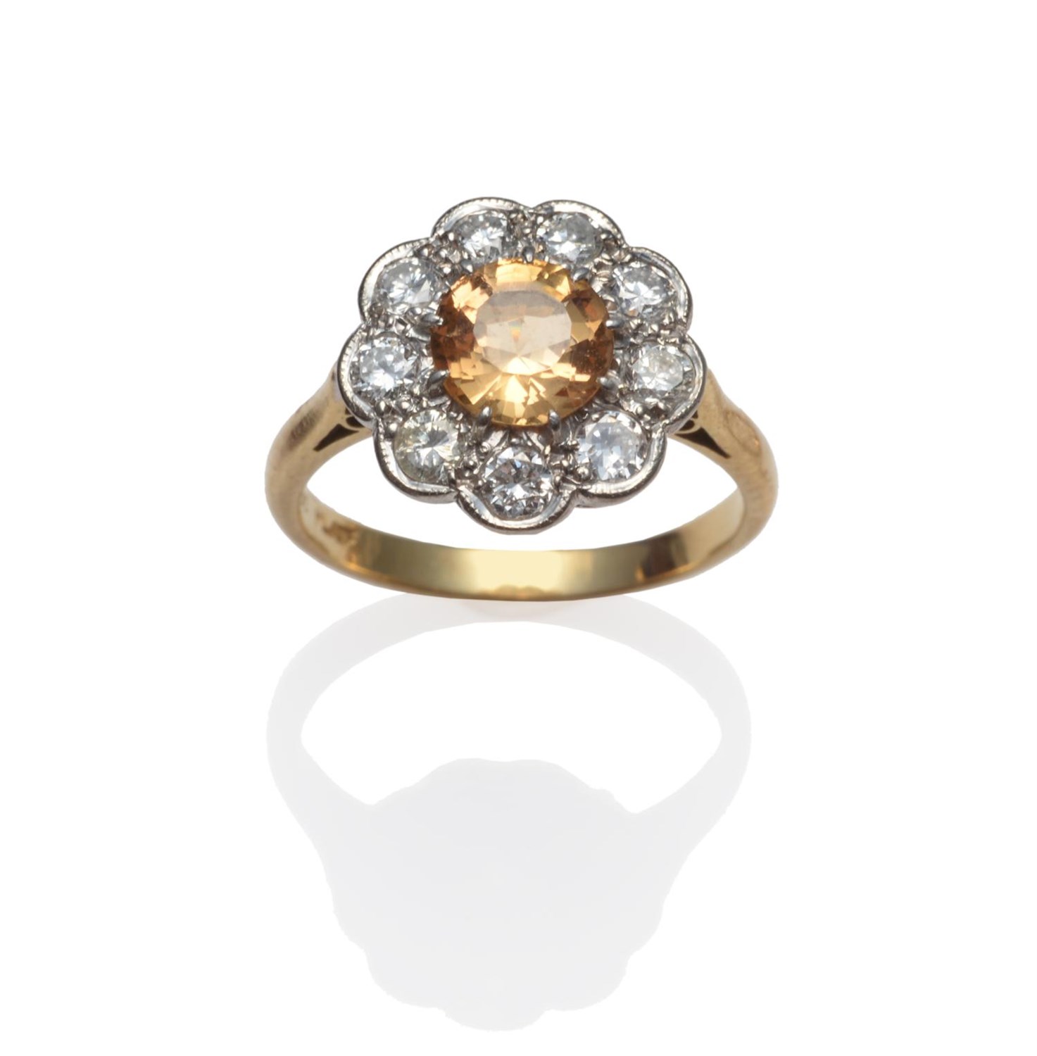 Lot 191 - A Topaz and Diamond Cluster Ring, the round