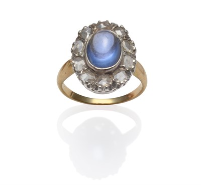 Lot 198 - A Sapphire and Diamond Cluster Ring, a cabochon pale blue sapphire within a border of rose cut...