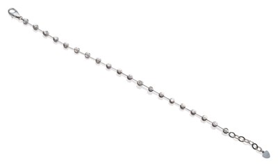 Lot 218 - A Diamond Line Bracelet, round brilliant cut diamonds in white collet settings, connected by...