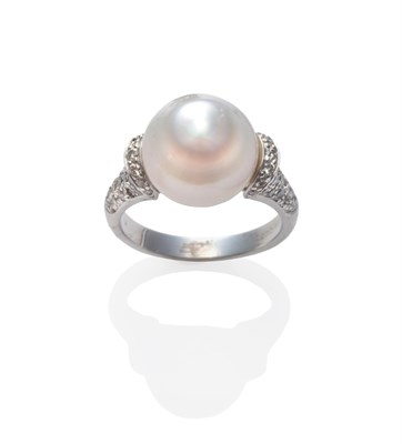 Lot 244 - A Cultured South Sea Pearl and Diamond Ring, the tapering cultured pearl within shoulders pavé set