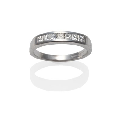 Lot 245 - An 18 Carat White Gold Diamond Half Hoop Ring, a row of princess cut diamonds channel set on a...