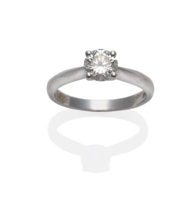 Lot 246 - A Platinum Diamond Solitaire Ring, a round brilliant cut diamond in a four claw setting, to tapered