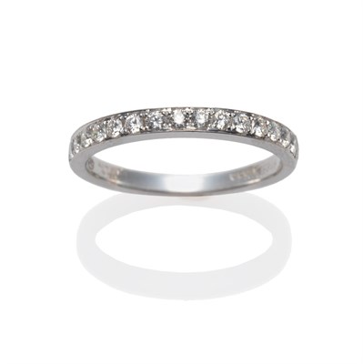 Lot 251 - An 18 Carat White Gold Diamond Half Hoop Ring, the round brilliant cut diamonds in white claw...