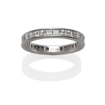 Lot 254 - A Diamond Eternity Ring, princess cut diamonds in a white channel setting, total estimated...