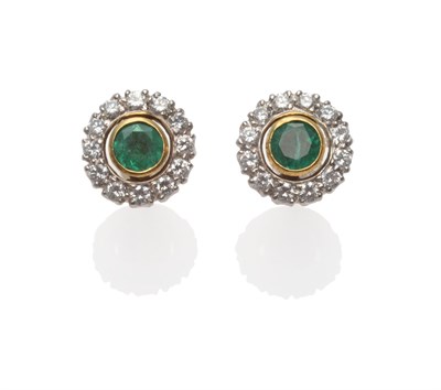 Lot 271 - A Pair of 18 Carat Gold Emerald and Diamond Cluster Earrings, a round cut emerald in a yellow...