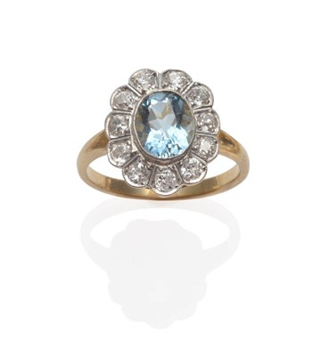 Lot 276 - An Aquamarine and Diamond Cluster Ring, an oval cut aquamarine within a border of old cut diamonds