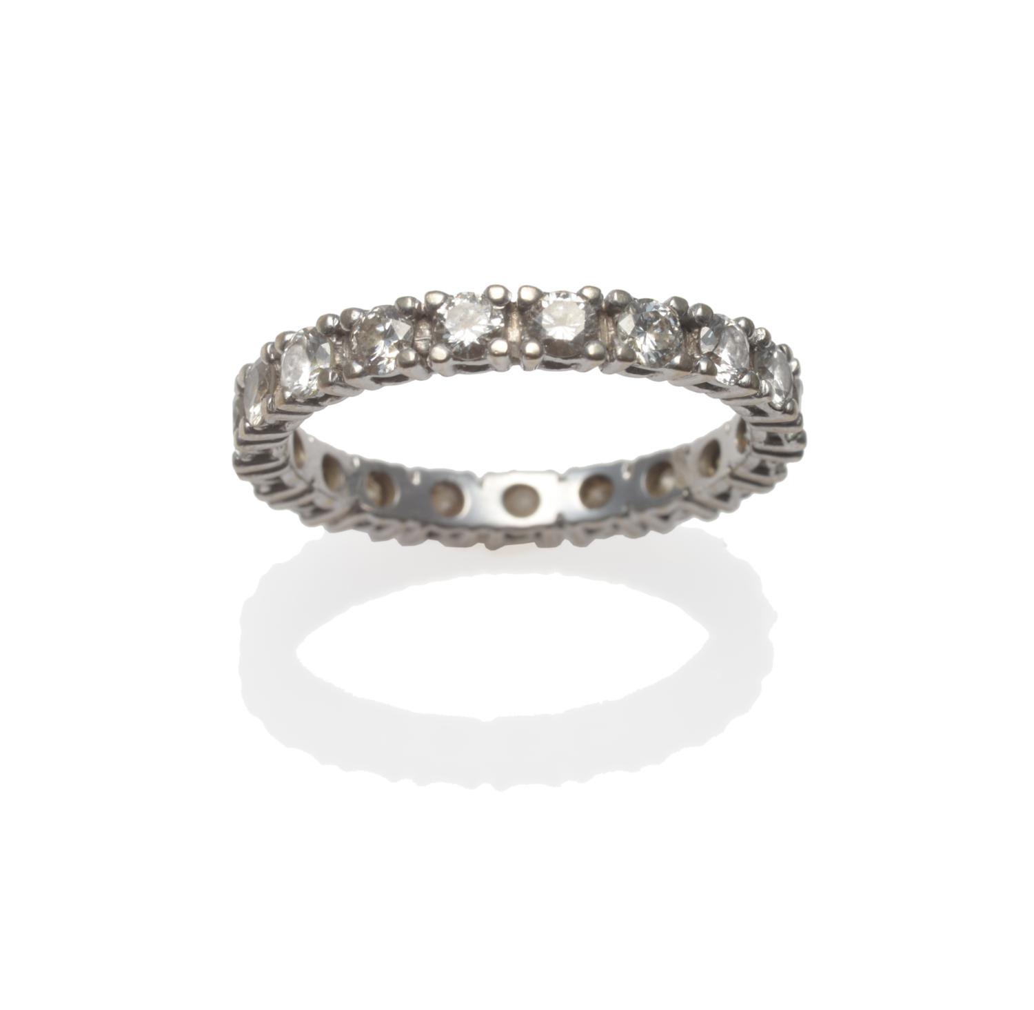 Lot 353 - A Diamond Full Eternity Ring, nineteen round brilliant cut diamonds in white claw settings,...