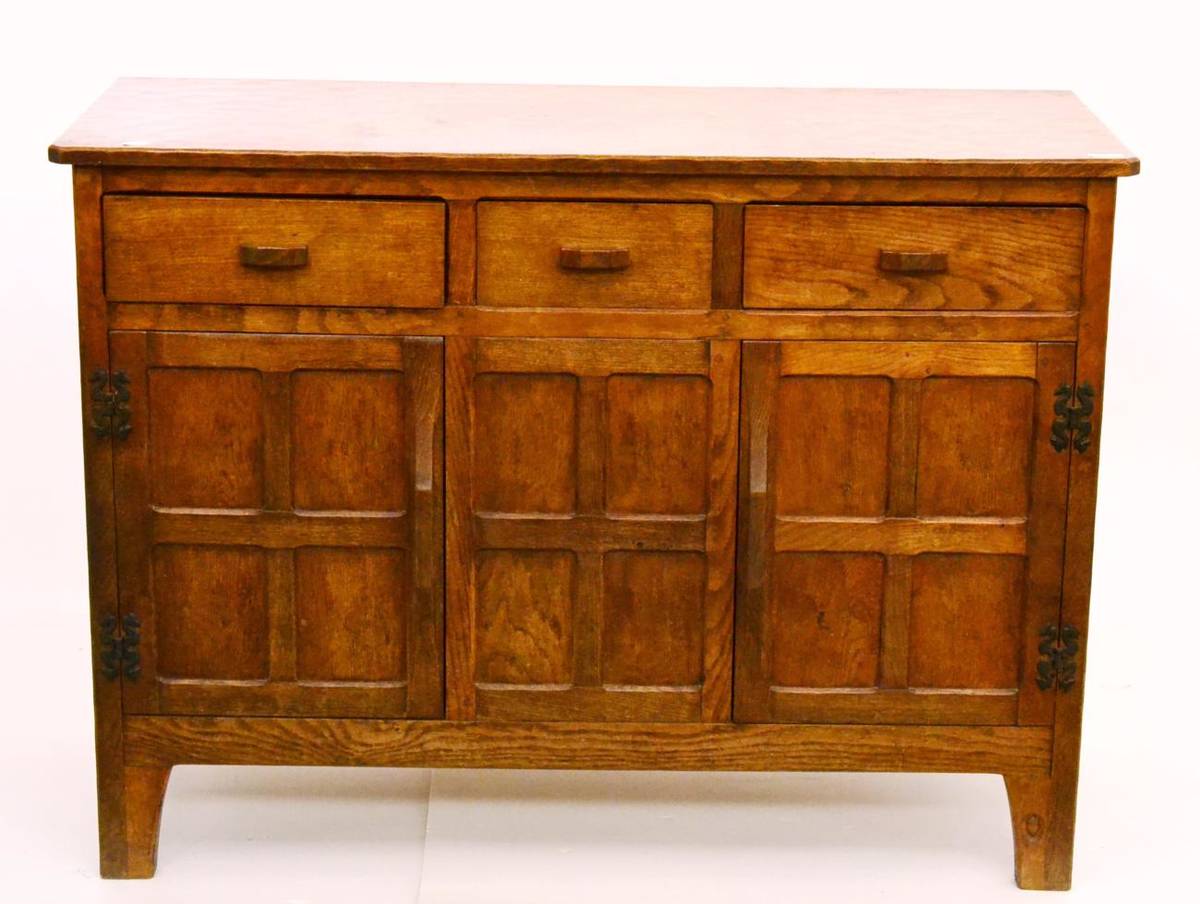 Lot 622 - An Alan Grainger Acorn Industries Oak Sideboard, with three drawers over two cupboard doors,...