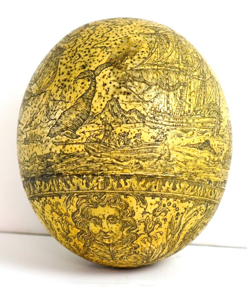 Lot 918 - A Scrimshaw Style Ostrich Egg, 20th century, decorated with a whaling scene over a frieze of...