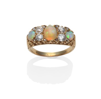 Lot 134 - An Opal and Diamond Ring, circa 1880, the graduated oval cabochon opals spaced by pairs of old...