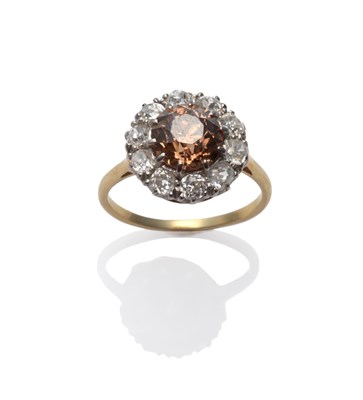 Lot 137 - A Brown and White Diamond Cluster Ring, an old cut brown diamond within a border of old cut...