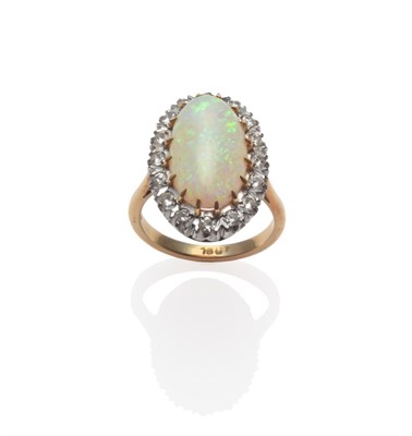 Lot 138 - An Opal and Diamond Ring, the oval cabochon opal within a border of round brilliant cut...