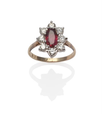 Lot 159 - A Ruby and Diamond Cluster Ring, the oval mixed cut ruby within a border of round brilliant cut...