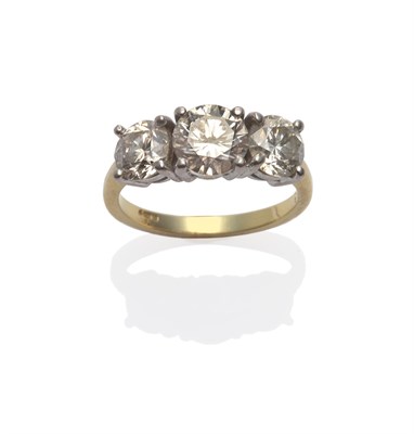 Lot 171 - An 18 Carat Gold Diamond Three Stone Ring, the graduated round brilliant cut diamonds in a...