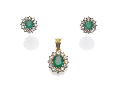 Lot 175 - An Emerald and Diamond Cluster Pendant, an oval cut emerald within a border of round brilliant...