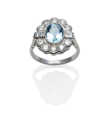 Lot 206 - An Aquamarine and Diamond Cluster Ring, the oval cut aquamarine within a border of round...