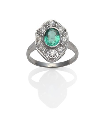 Lot 210 - An Emerald and Diamond Cluster Ring, an oval cut emerald within a pierced frame inset with old...