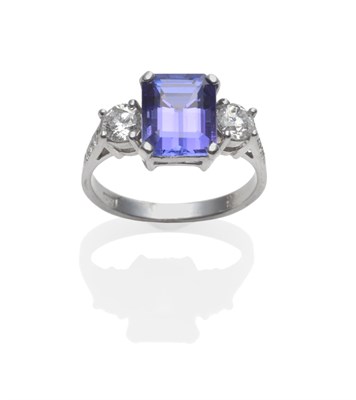 Lot 212 - A Tanzanite and Diamond Ring, the emerald-cut tanzanite flanked by a round brilliant cut diamond on