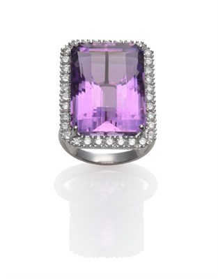 Lot 215 - An 18 Carat White Gold Amethyst and Diamond Cluster Ring, the emerald-cut amethyst within a...