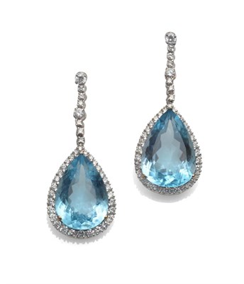 Lot 219 - A Pair of Blue Topaz and Diamond Drop Earrings, a row of round brilliant cut diamonds suspends...